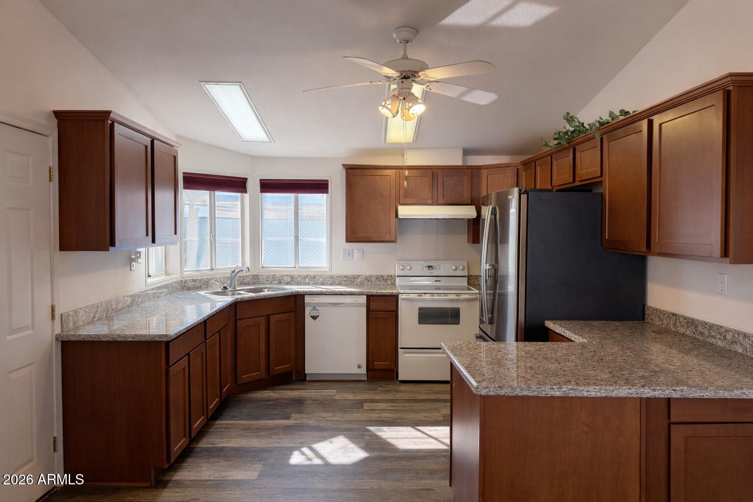 3700 South Tomahawk Road, Unit 13 Apache Junction, AZ 85119 - Photo 6 of 19 a kitchen with stainless steel appliances granite countertop a sink stove and refrigerator