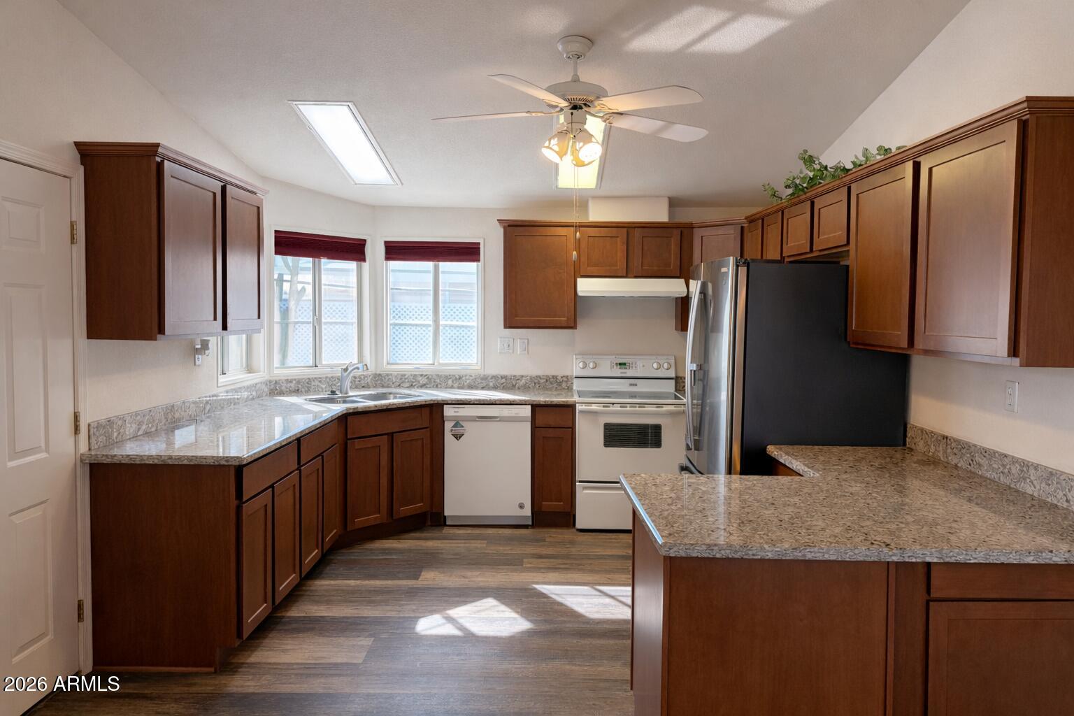 3700 South Tomahawk Road, Unit 13 Apache Junction, AZ 85119 - Photo 7 of 19 a kitchen with stainless steel appliances granite countertop a sink stove and refrigerator