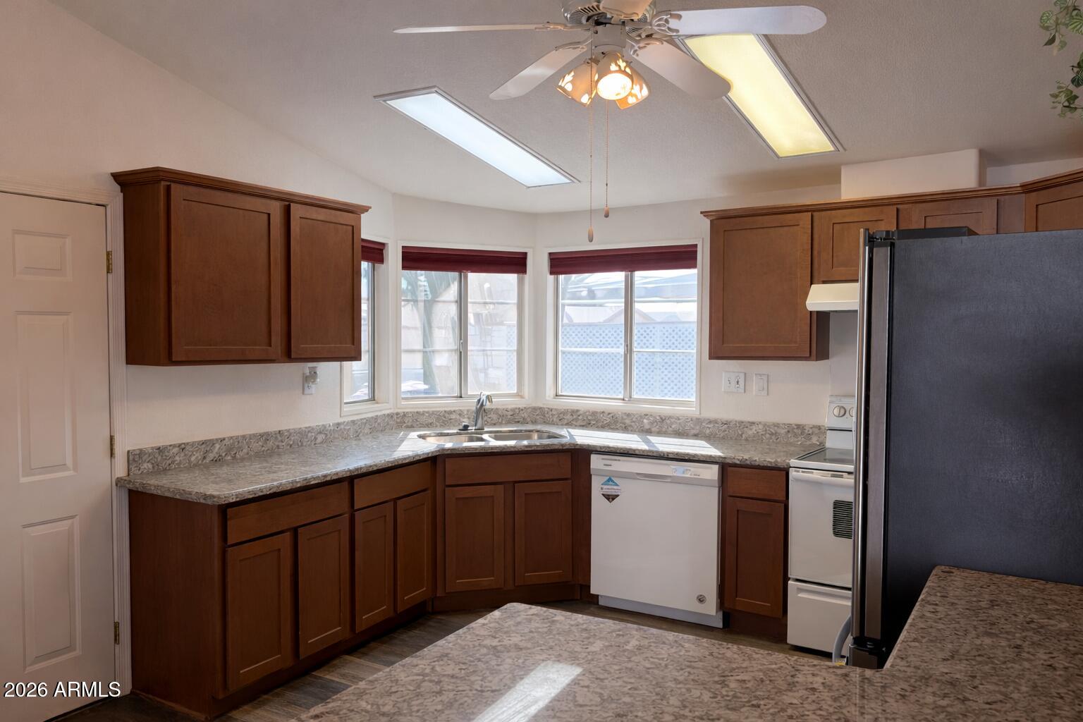 3700 South Tomahawk Road, Unit 13 Apache Junction, AZ 85119 - Photo 8 of 19 a kitchen with a sink and cabinets