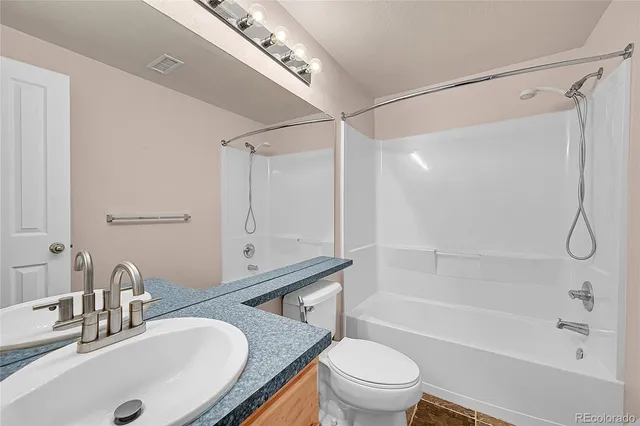 a view of washer and dryer with kitchen in the background