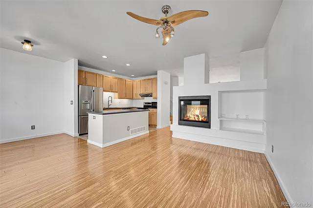 a kitchen with stainless steel appliances granite countertop a refrigerator sink and stove