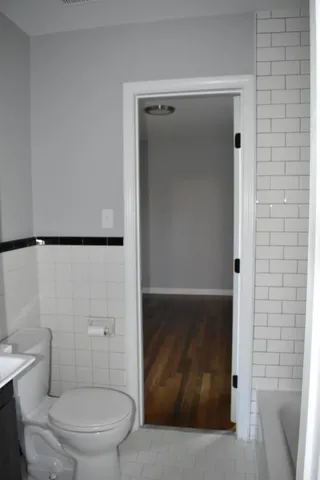 a bathroom with a toilet and a shower