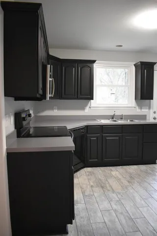 a kitchen with a sink and a stove