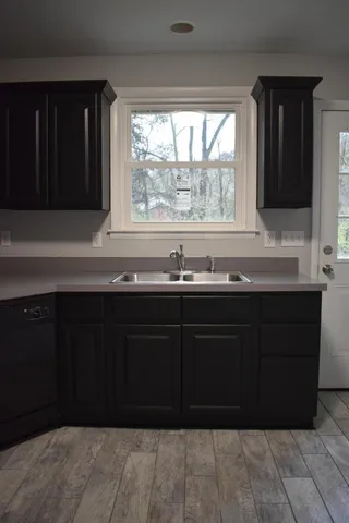 a kitchen with granite countertop a sink and a window