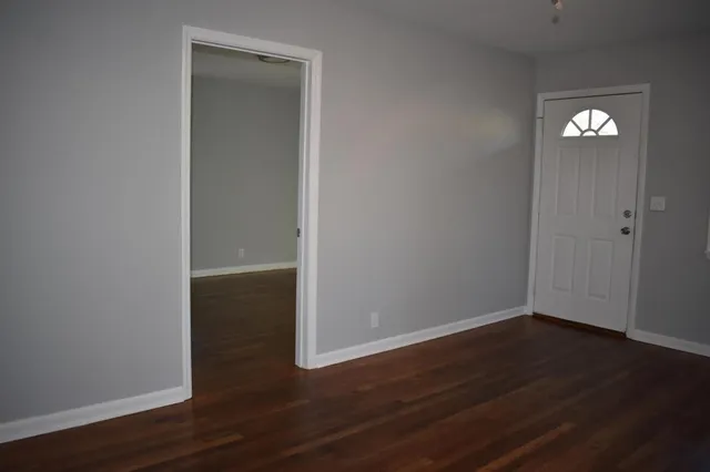 a view of a room with wooden floor