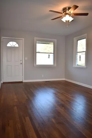 a view of wooden floor and windows in a room