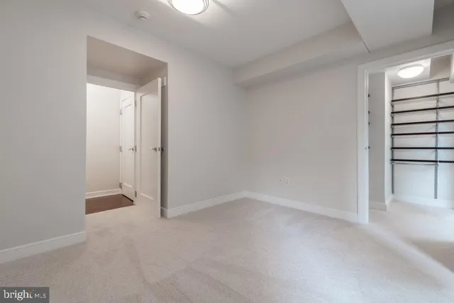 a view of an empty room and closet area