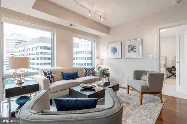 a living room with furniture and a large window