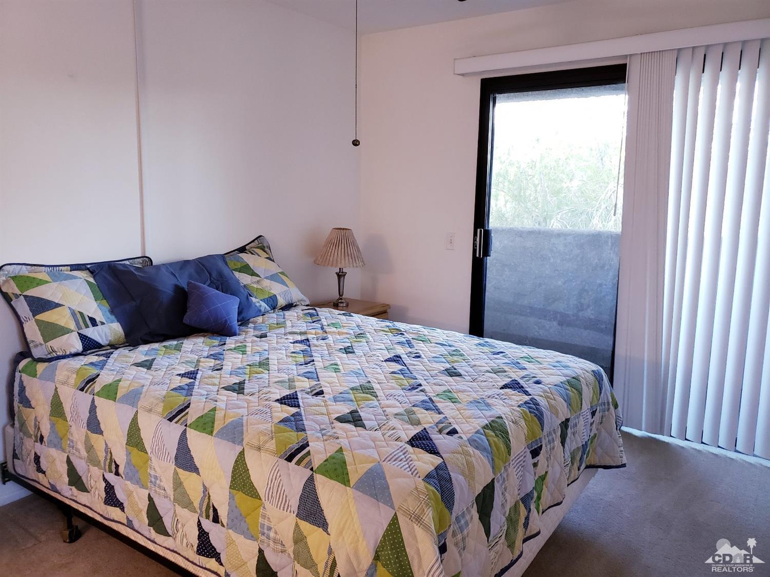 69575 Karen Way Rancho Mirage, CA 92270 - Photo 7 of 14 a bedroom with a bed and a window
