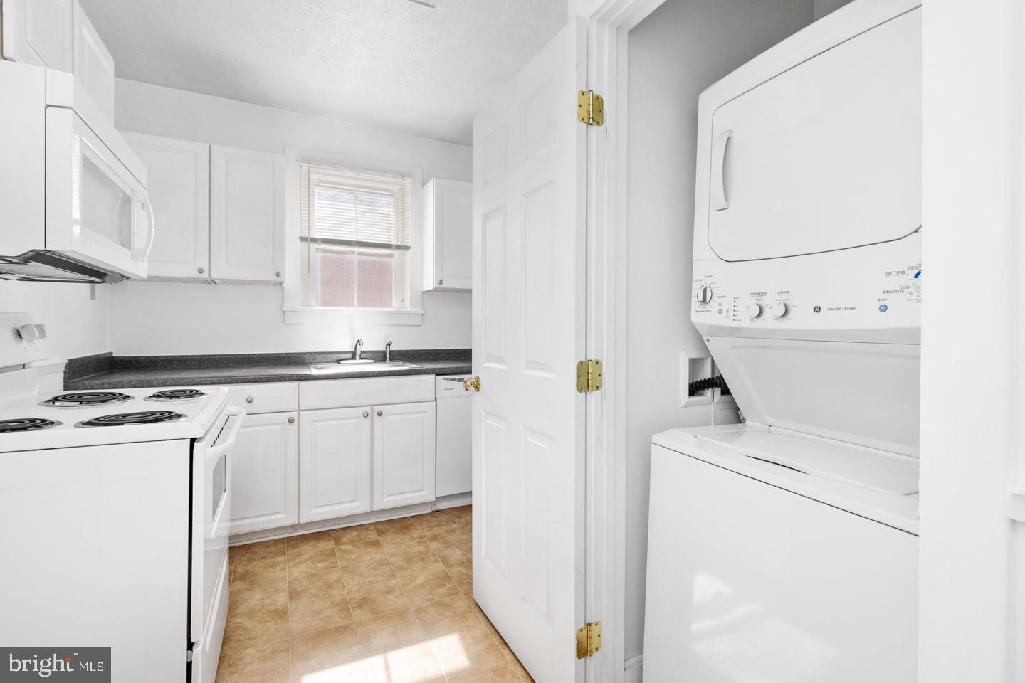 702 South Braddock Street, Unit 3 Winchester, VA 22601 - Photo 8 of 12 a kitchen with a stove a sink and a microwave
