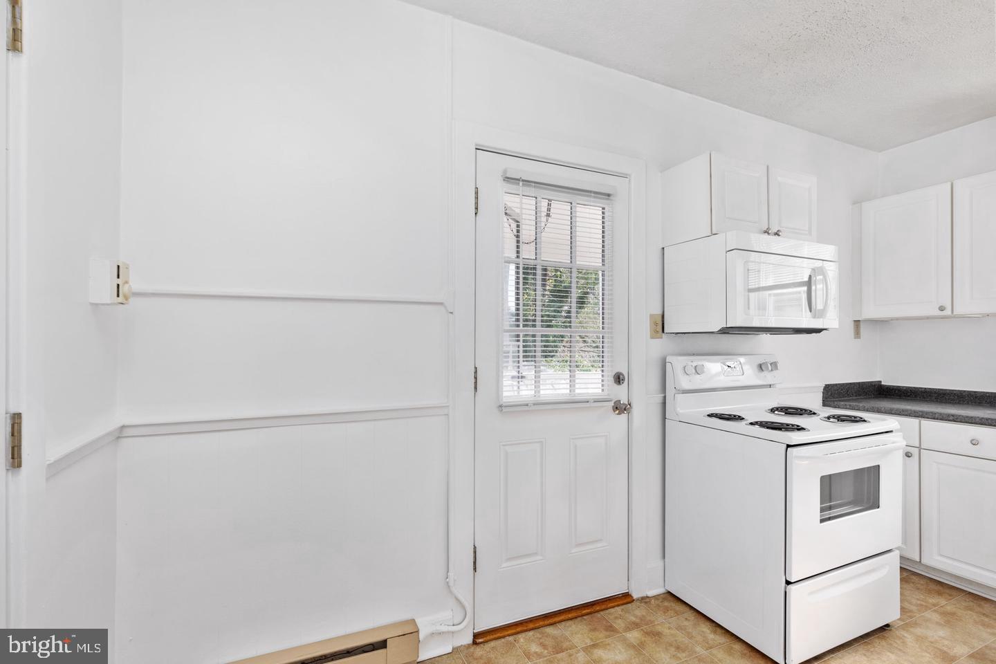 702 South Braddock Street, Unit 3 Winchester, VA 22601 - Photo 10 of 12 a kitchen with white cabinets and white appliances