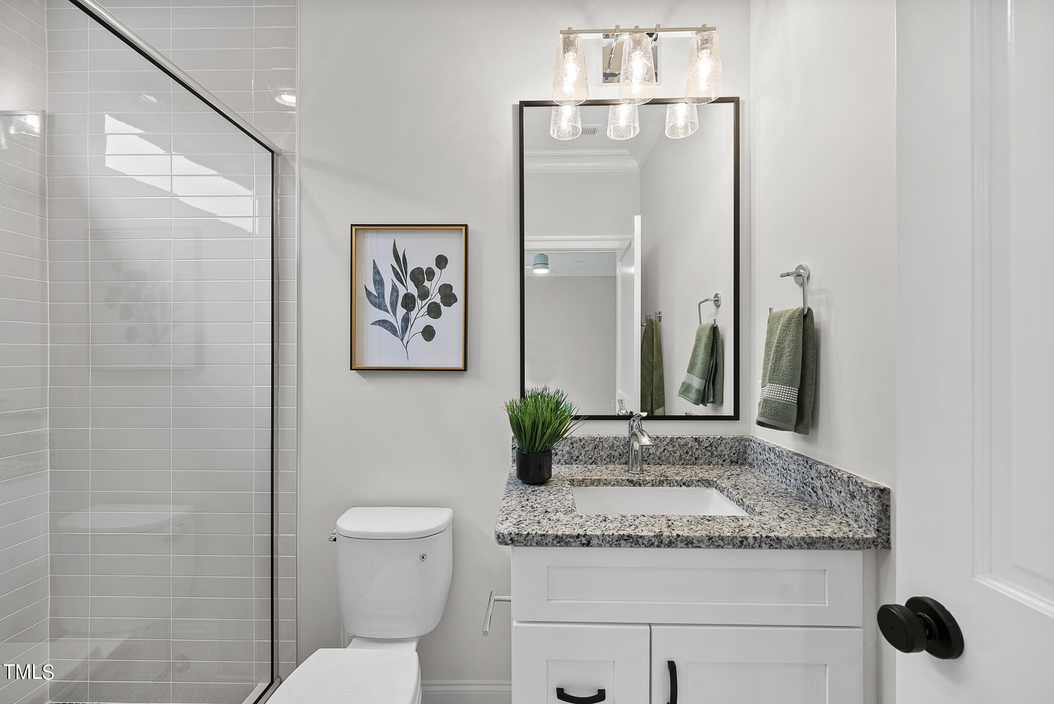 9400 Rawson Avenue Raleigh, NC 27613 - Photo 23 of 33 a bathroom with a granite countertop sink a toilet and a mirror
