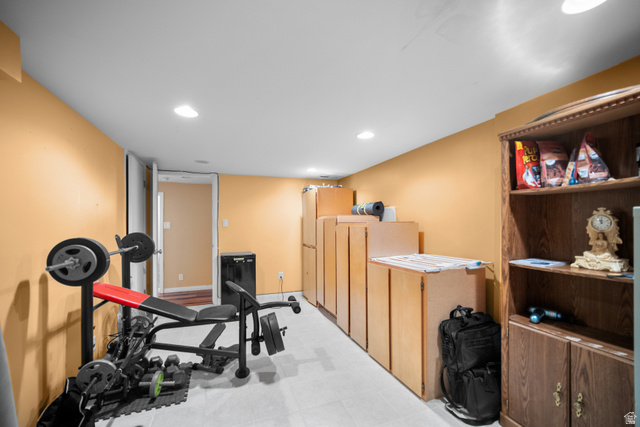 3233 Jean Street Magna, UT 84044 - Photo 29 of 33 Versatile lower level space featuring recessed lighting, light-colored flooring, warm-toned walls, and a built-in storage system with multiple cabinets