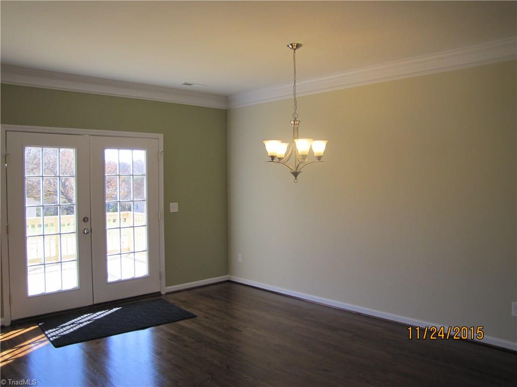 3627 Ruby Road Winston-Salem, NC 27106 - Photo 4 of 30 Dining Room. This home features designer inspired paint colors, hardwood floors, crown molding, can lights and beautiful light fixtures. Doors lead out to large Deck.
