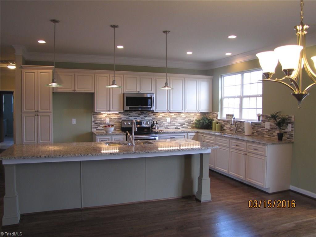 3627 Ruby Road Winston-Salem, NC 27106 - Photo 6 of 30 Tons of Granite counters! All wood cabinets with soft close drawers, tile backsplash, can lights and pendants and all new stainless steel built-in MW & DW as well as freestanding range/oven.