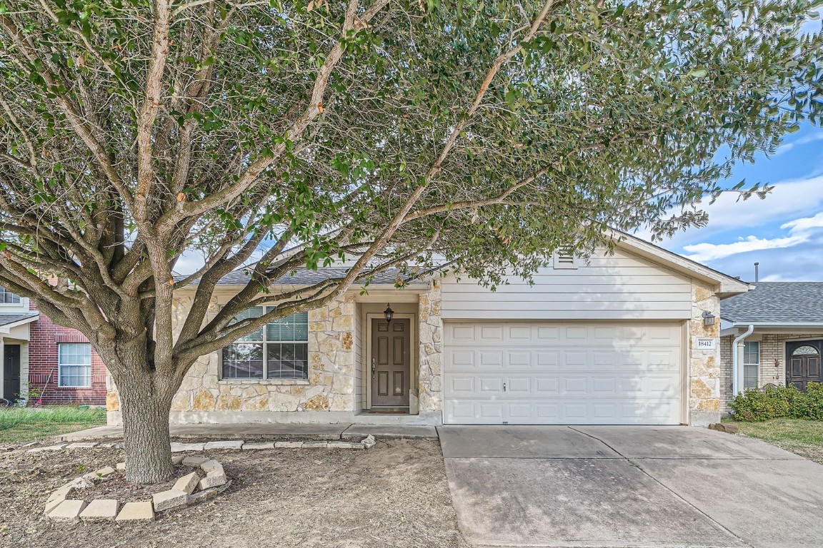 18412 Cloudmore Lane Elgin, TX 78621 - Photo 1 of 1 a front view of a house with yard and trees