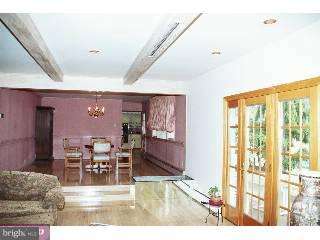 1211 Cox Road Rydal, PA 19046 - Photo 4 of 6 a living room with furniture a dining table and a large window