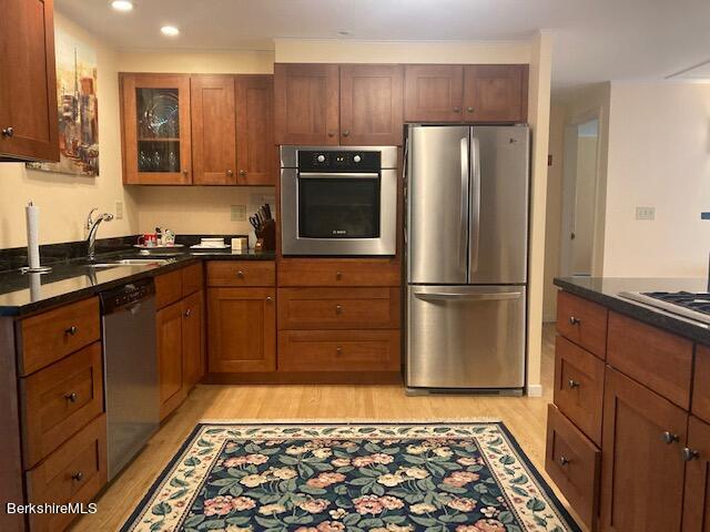 a kitchen with stainless steel appliances granite countertop a refrigerator and a sink