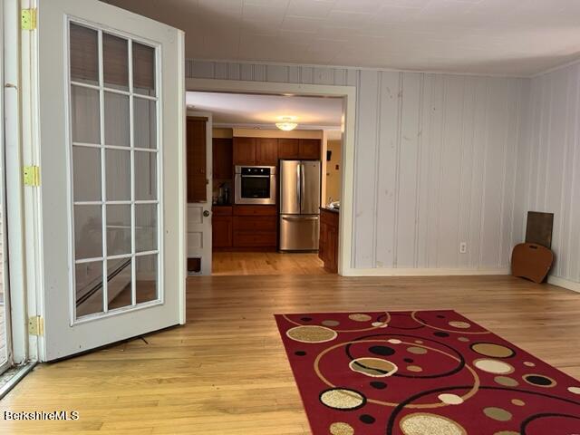 85 Pixley Road Monterey, MA 01230 - Photo 19 of 20 a view of an empty room with wooden floor and a kitchen