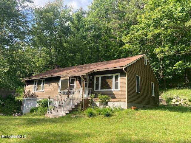 85 Pixley Road Monterey, MA 01230 - Photo 3 of 20 a view of a backyard with plants and large tree