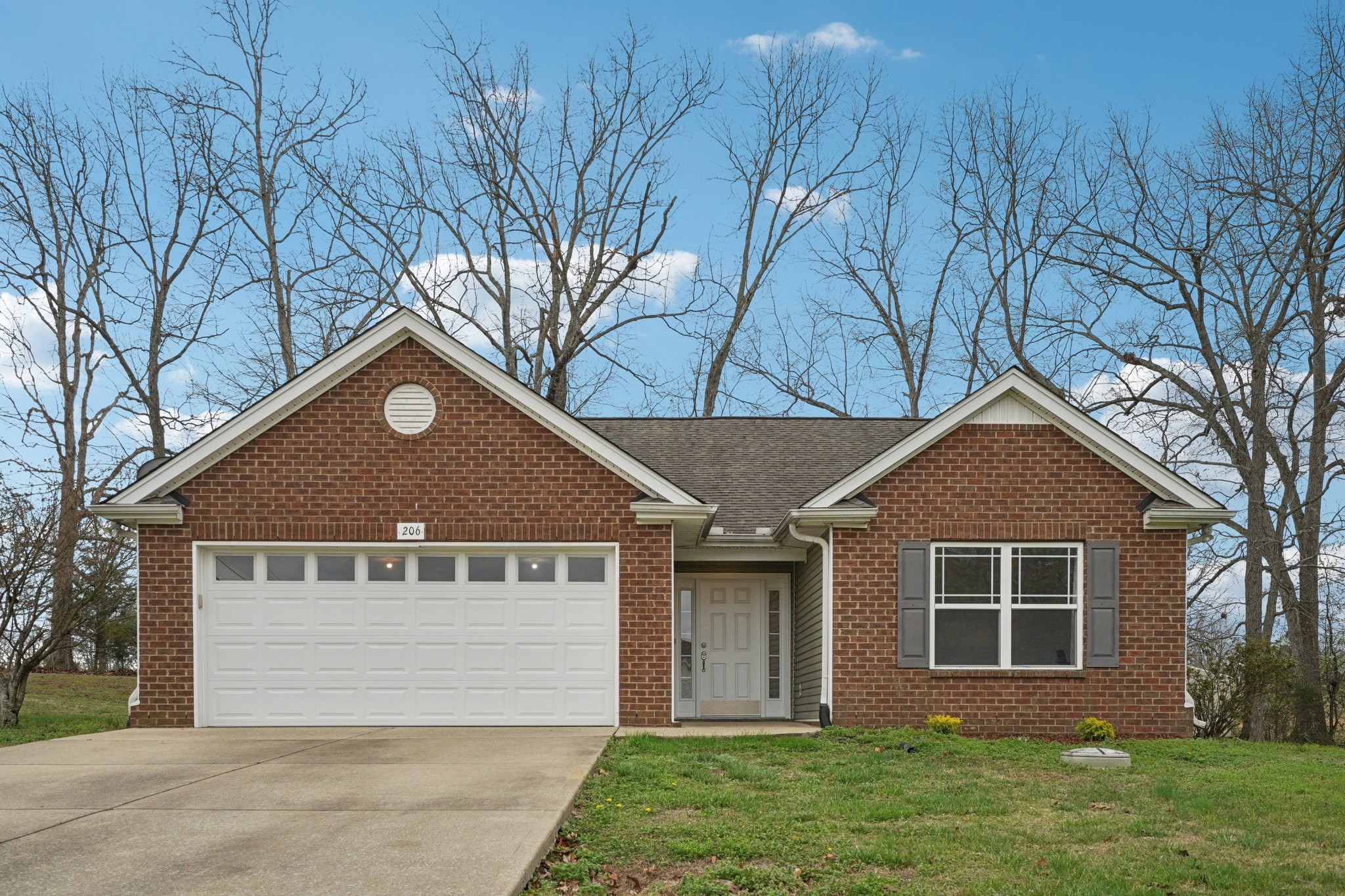 206 Hickory Pointe Dickson, TN 37055 - Photo 1 of 28 a front view of a house with garden