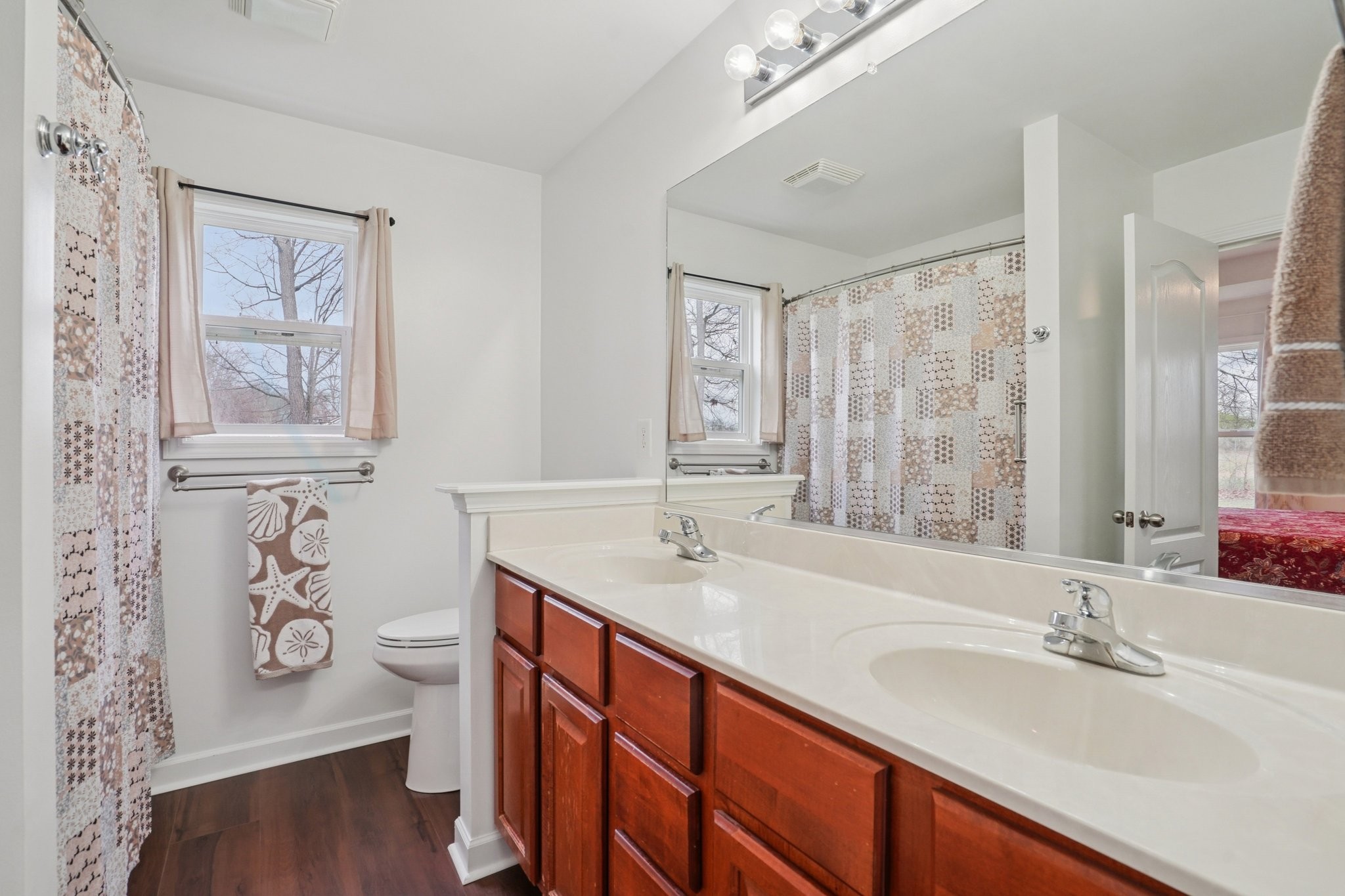 206 Hickory Pointe Dickson, TN 37055 - Photo 22 of 28 a bathroom with double vanity sink a mirror and a toilet