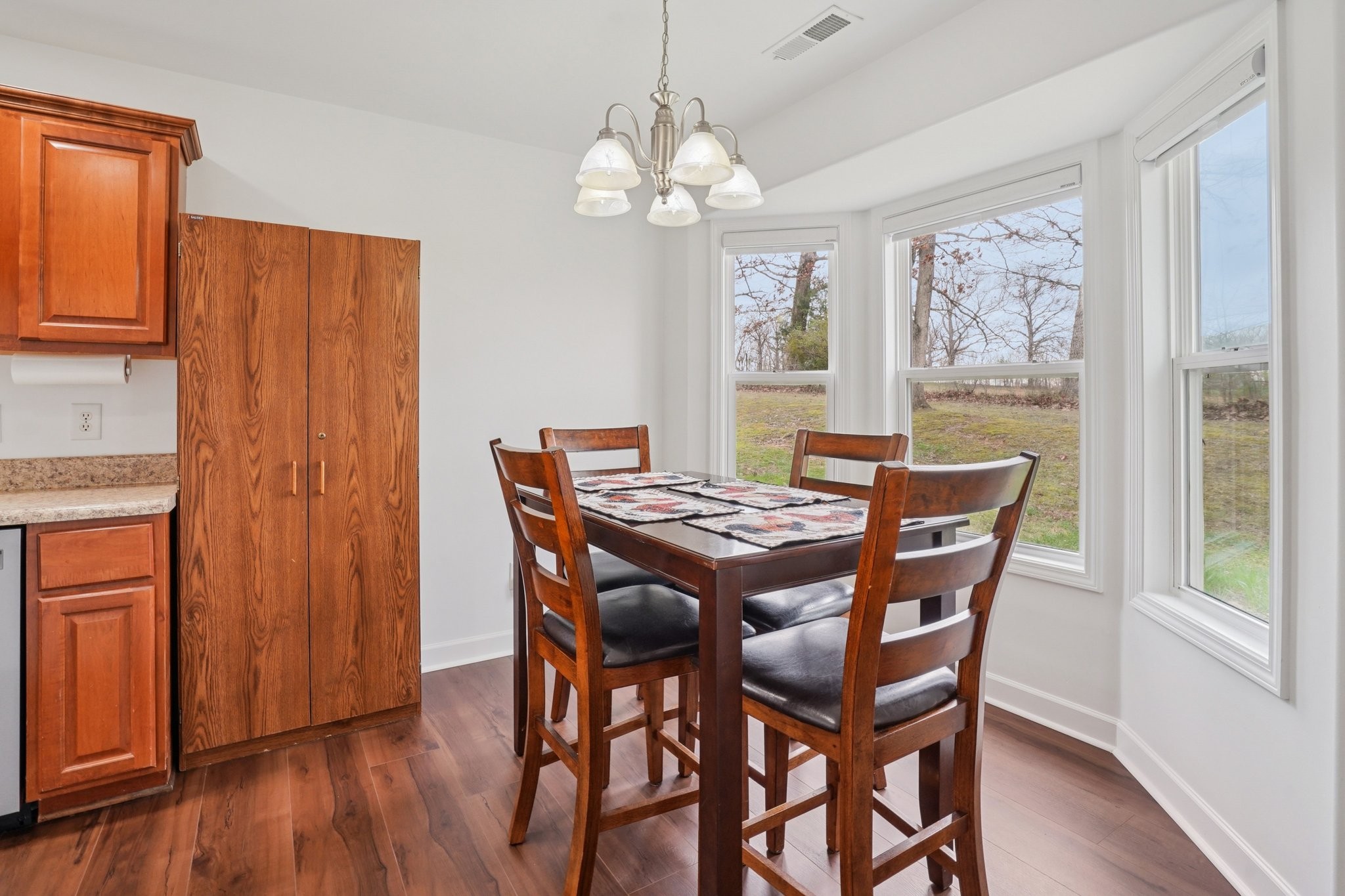 206 Hickory Pointe Dickson, TN 37055 - Photo 9 of 28 a dining room with wooden floor a chandelier a wooden table and chairs