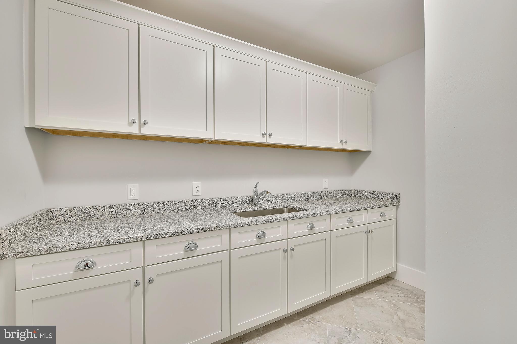 11710 Smoketree Road Potomac, MD 20854 - Photo 23 of 30 Laundry room with custom built in cabinetry