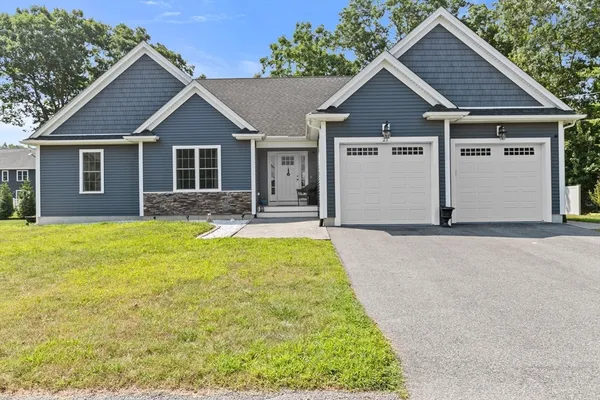 a front view of a house with a garden