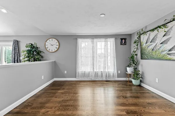 a view of entryway with window and wooden floor
