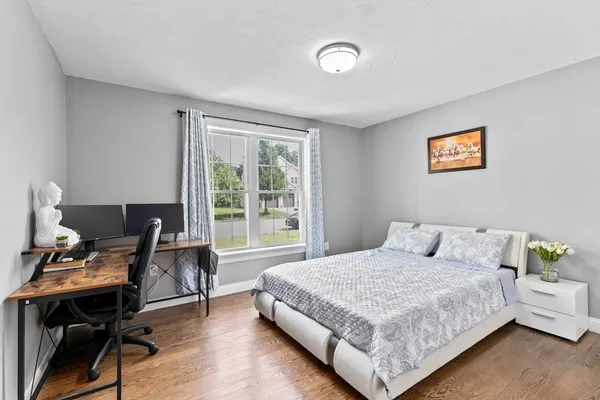 a bedroom with a bed and a desk