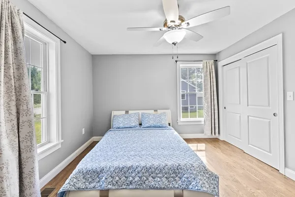 a large bedroom with a large bed and a chandelier