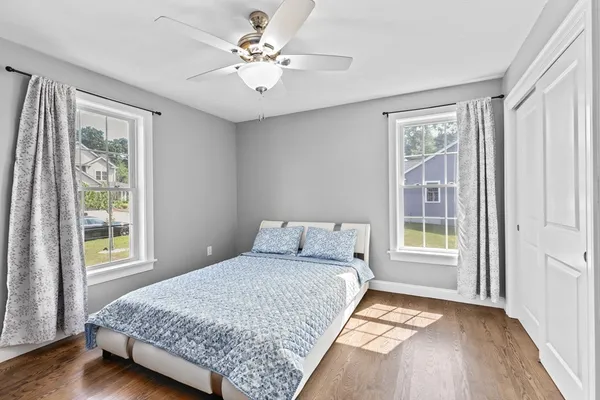 a bedroom with a large bed and a window