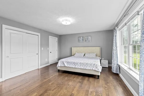 a bedroom with a bed and a large window