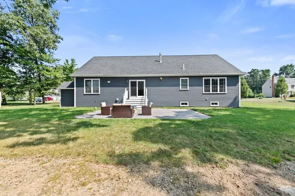 a front view of house with yard and green space