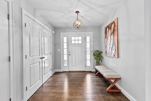 a very nice looking room with wooden floor and windows