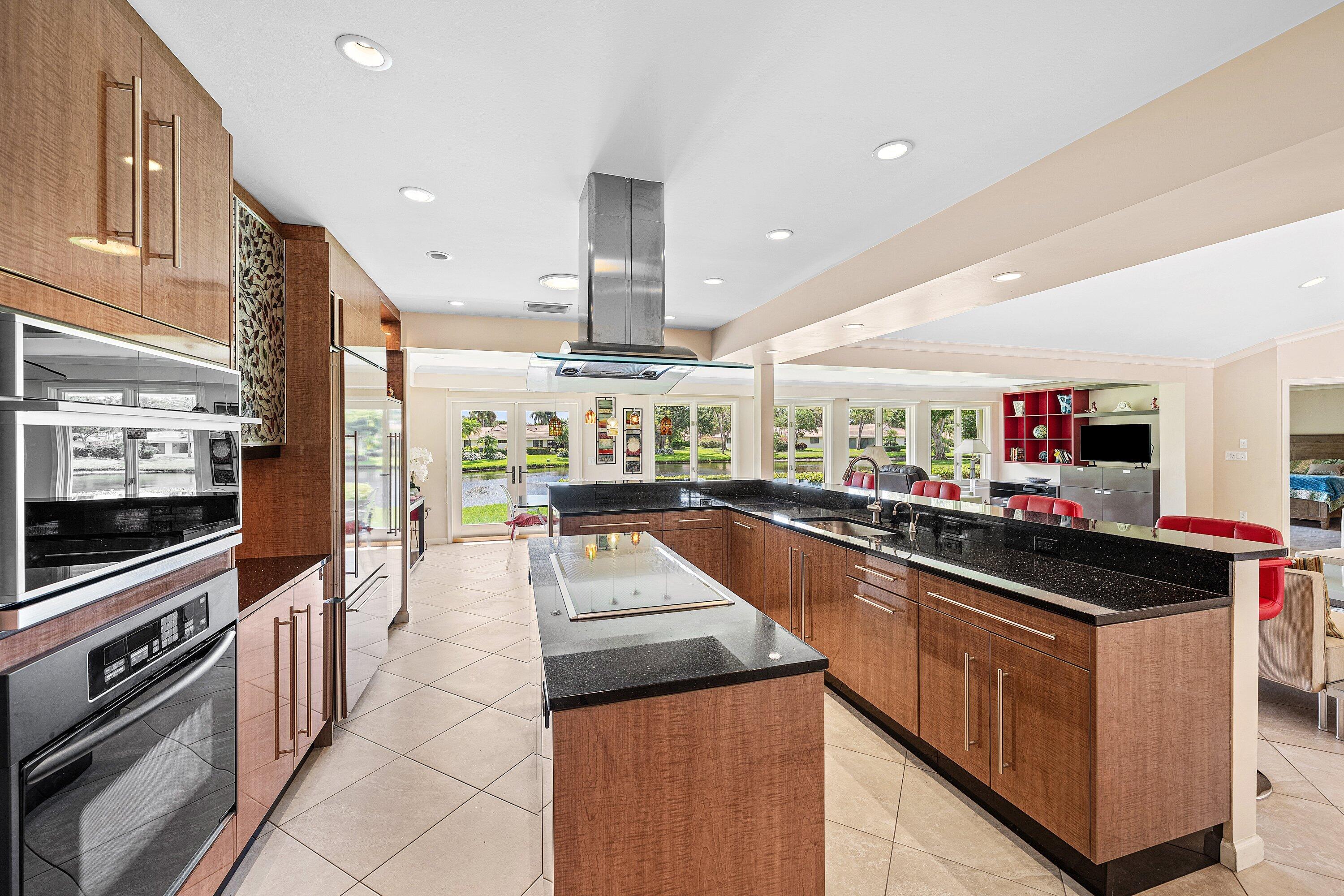 4365 Shell Drake Lane Boynton Beach, FL 33436 - Photo 5 of 56 a kitchen with stainless steel appliances kitchen island granite countertop a stove and a sink