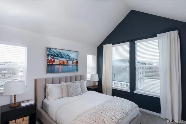 a bedroom with bed and a large window