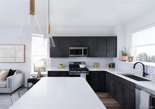 a kitchen with a sink a stove and cabinets