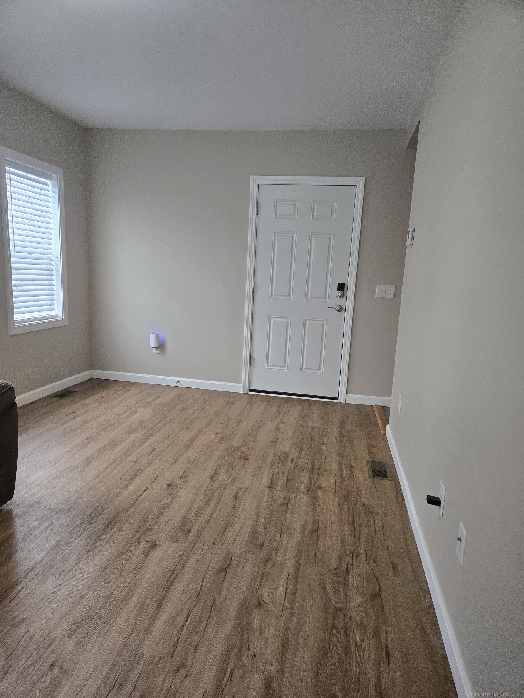 112 Liberty Street Pawcatuck, CT 06379 - Photo 14 of 22 wooden floor in an empty room with a window