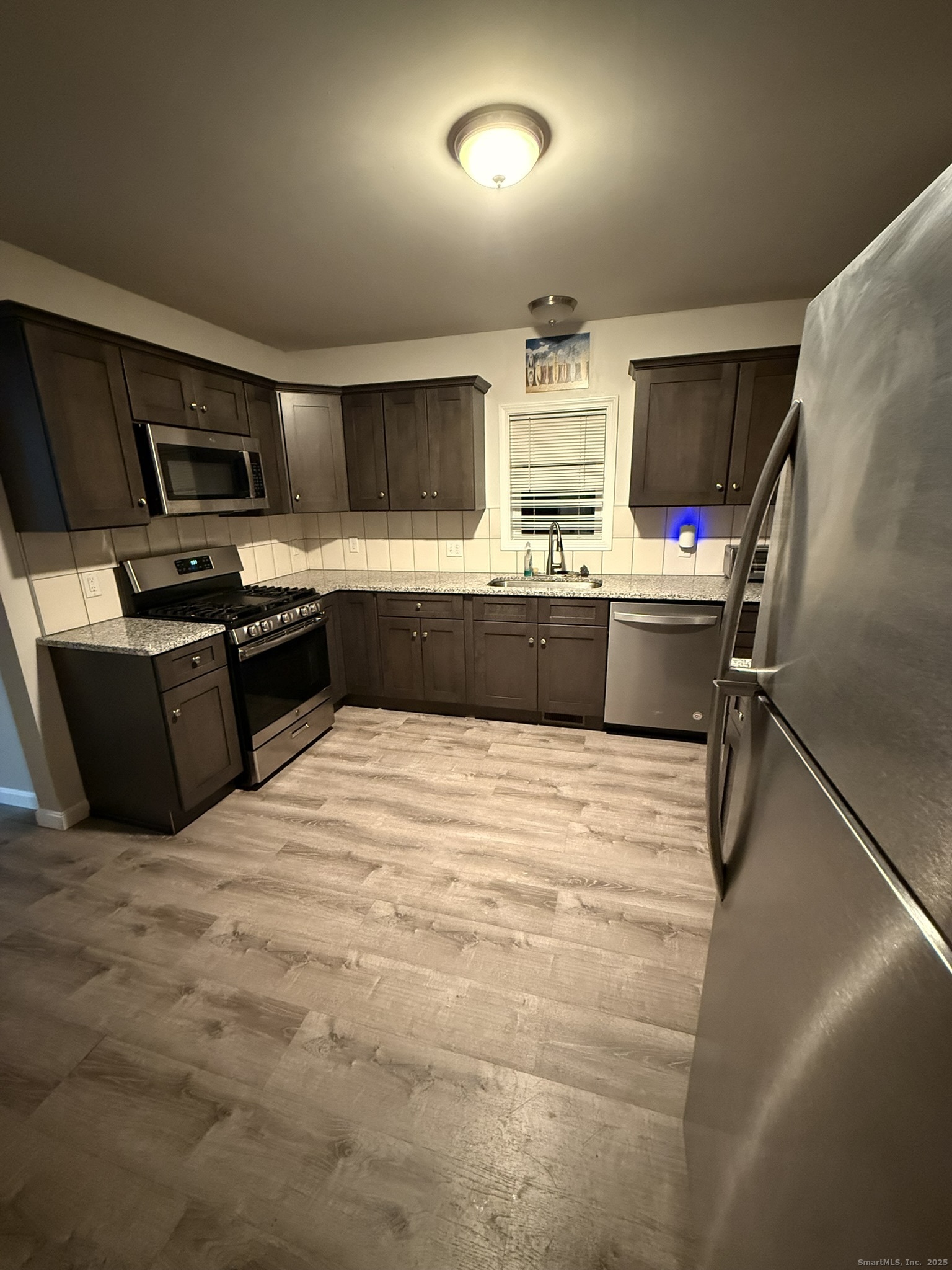 112 Liberty Street Pawcatuck, CT 06379 - Photo 18 of 22 a large kitchen with a stove a refrigerator and a kitchen island