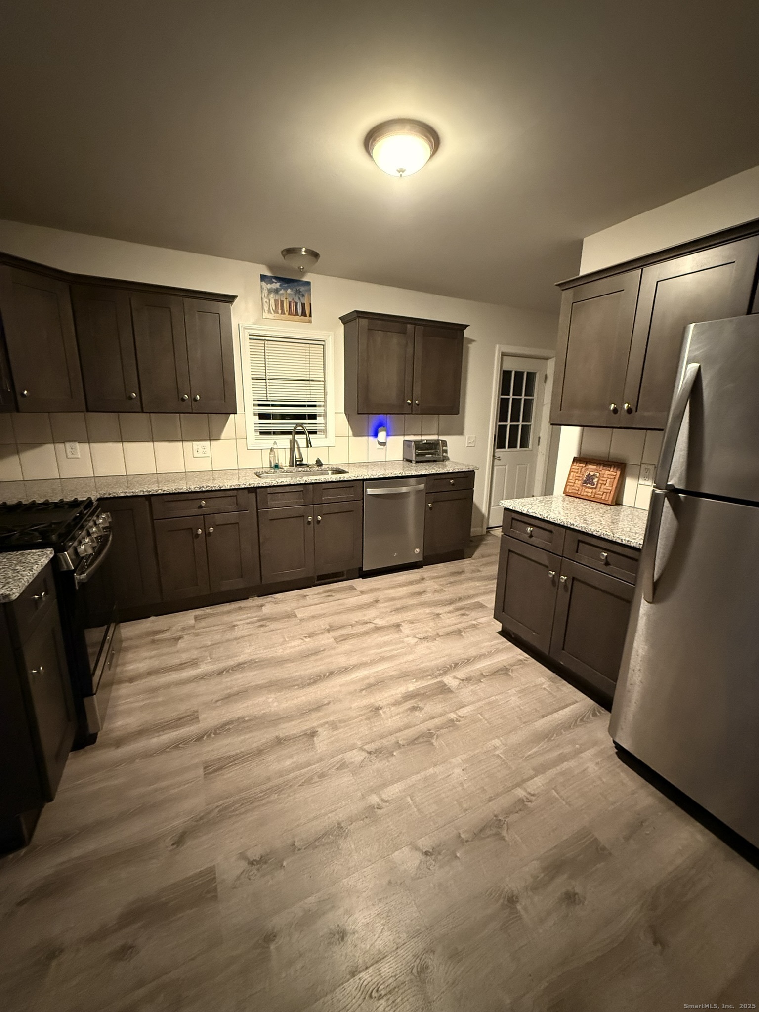 112 Liberty Street Pawcatuck, CT 06379 - Photo 19 of 22 a large kitchen with kitchen island a sink stainless steel appliances and cabinets