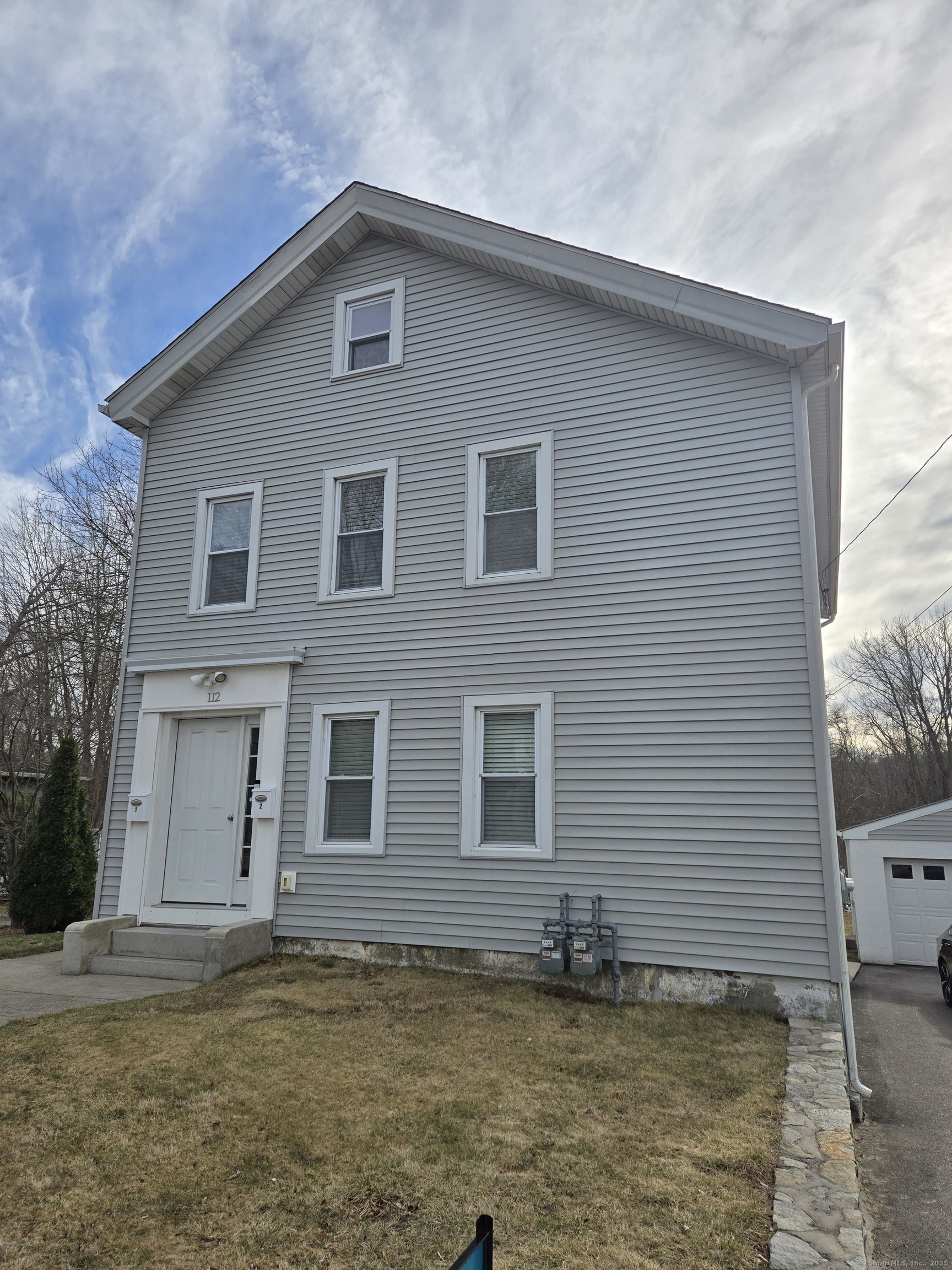 112 Liberty Street Pawcatuck, CT 06379 - Photo 2 of 22 a front view of a house with a yard
