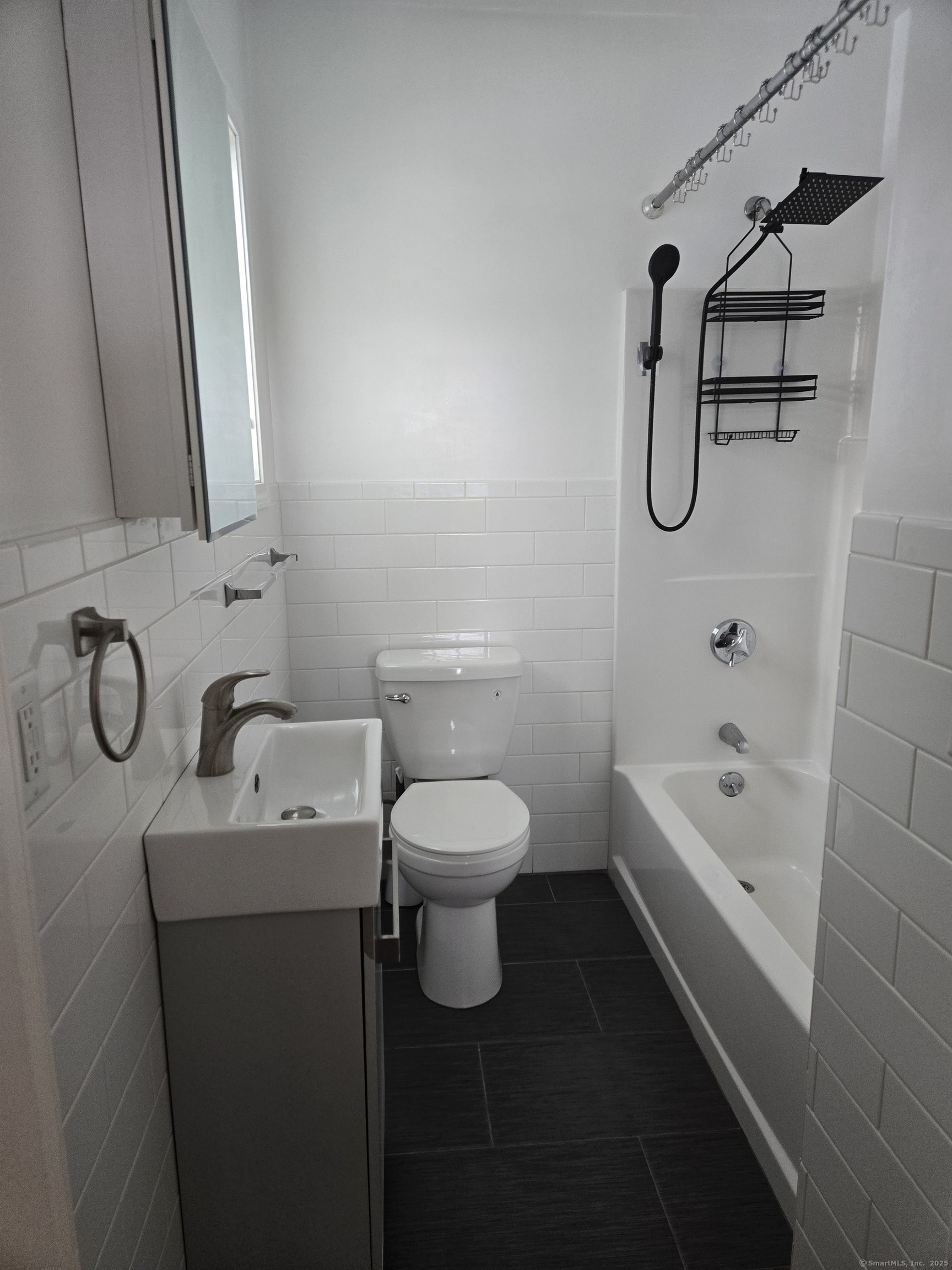112 Liberty Street Pawcatuck, CT 06379 - Photo 7 of 22 a bathroom with a granite countertop toilet a sink and a bathtub