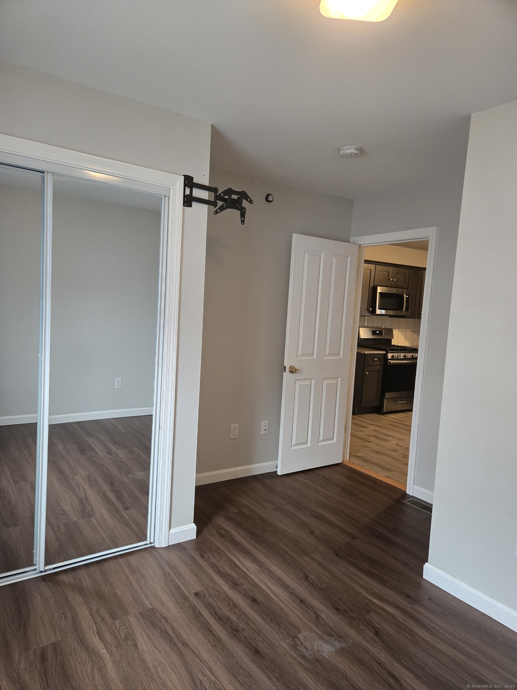 112 Liberty Street Pawcatuck, CT 06379 - Photo 9 of 22 a view of empty room with wooden floor