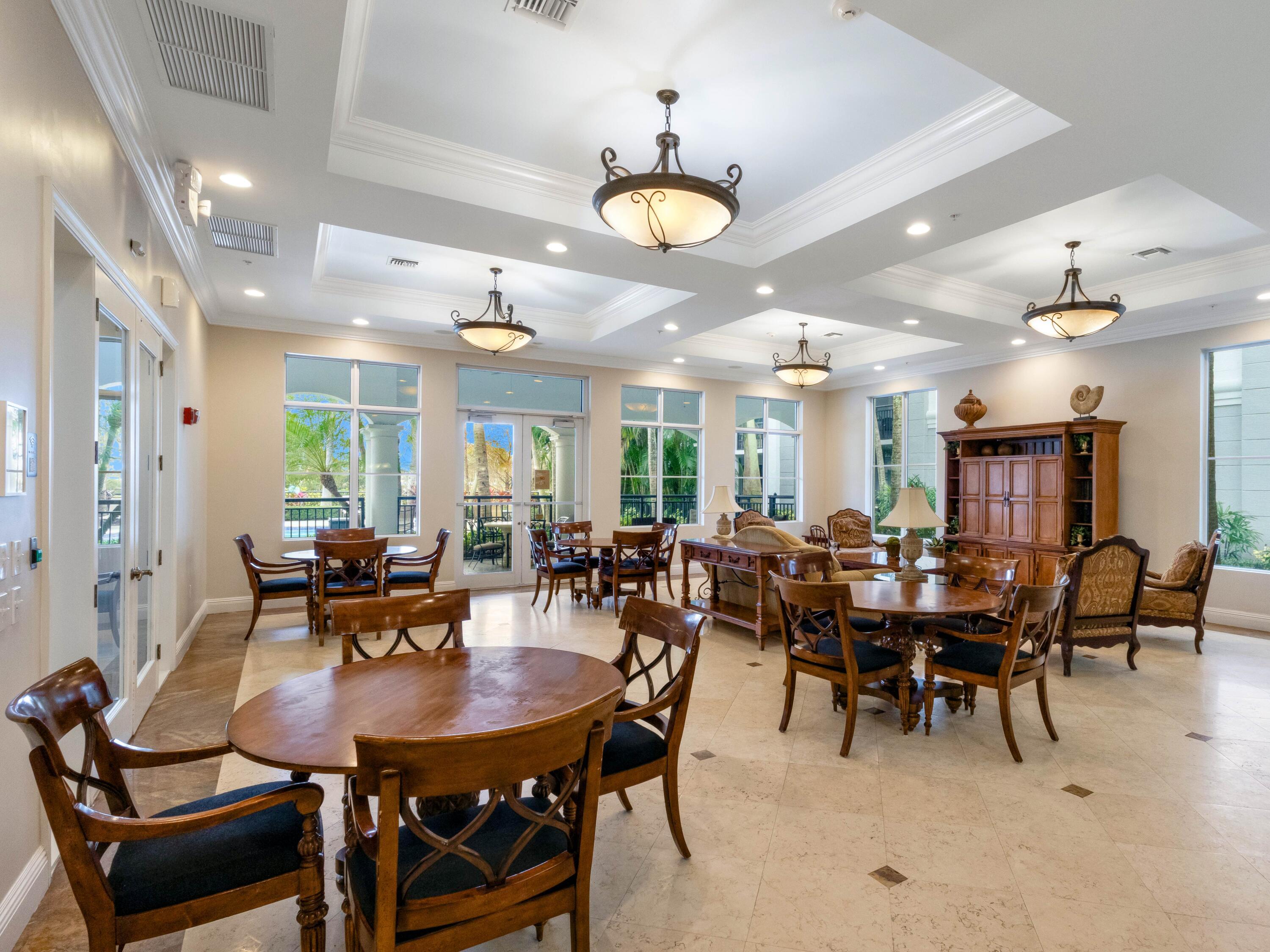 1690 Renaissance Commons Boulevard, Unit 1412 Boynton Beach, FL 33426 - Photo 40 of 49 a view of a dining room with furniture and chandelier