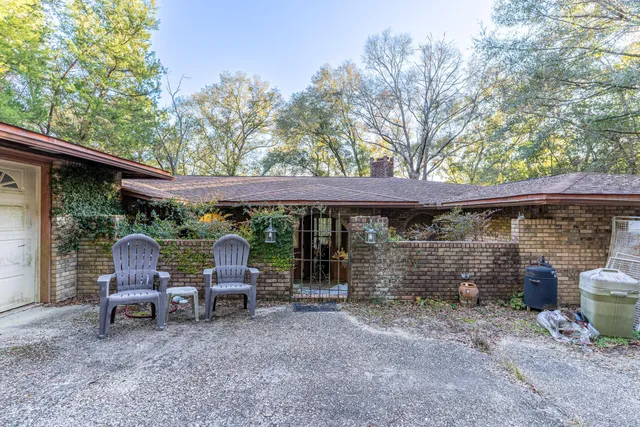 a view of patio with table and chairs and couches