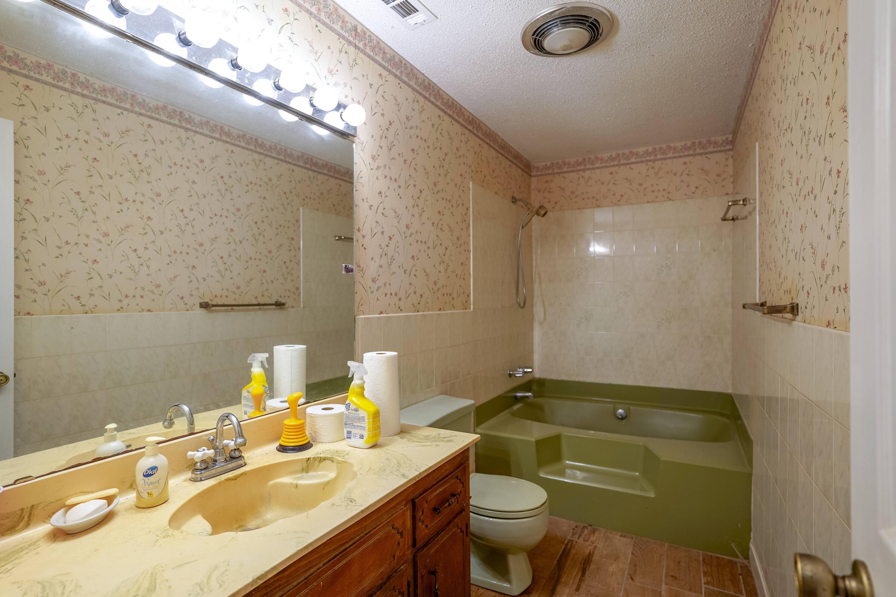 4444 Sundance Way Holt, FL 32564 - Photo 12 of 39 a bathroom with a granite countertop sink mirror vanity and toilet