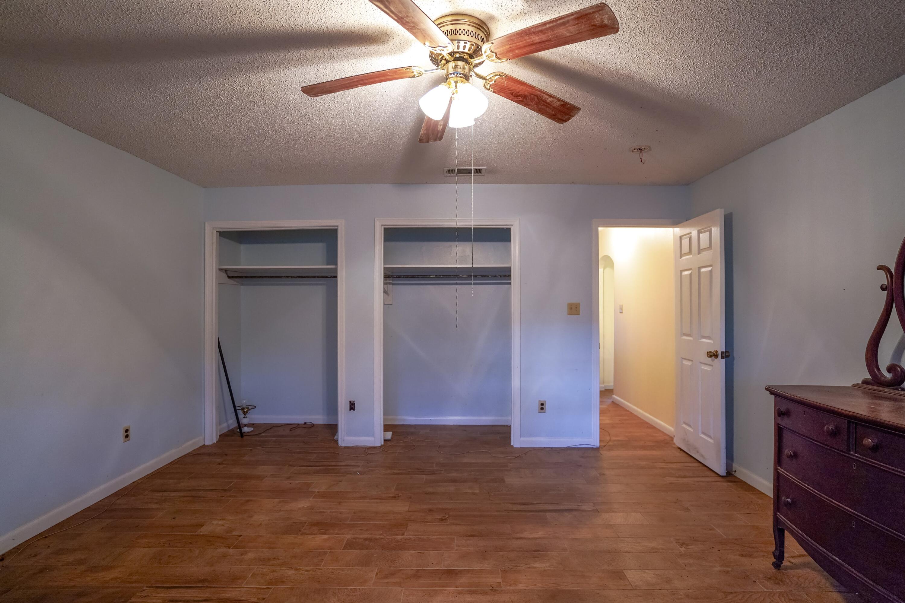 4444 Sundance Way Holt, FL 32564 - Photo 15 of 39 an empty room with closet and wooden floor