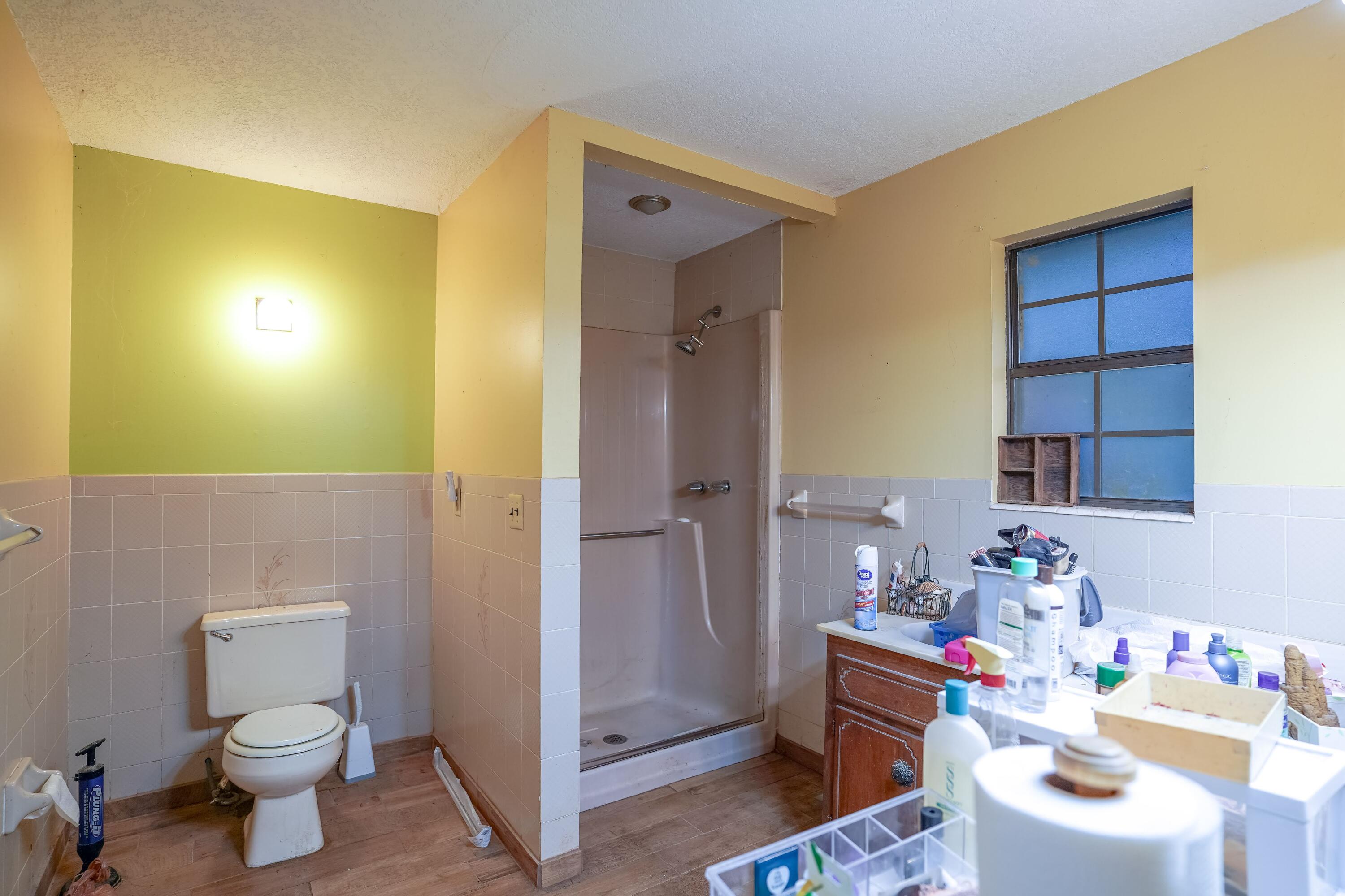 4444 Sundance Way Holt, FL 32564 - Photo 27 of 39 a bathroom with a sink mirror vanity and toilet